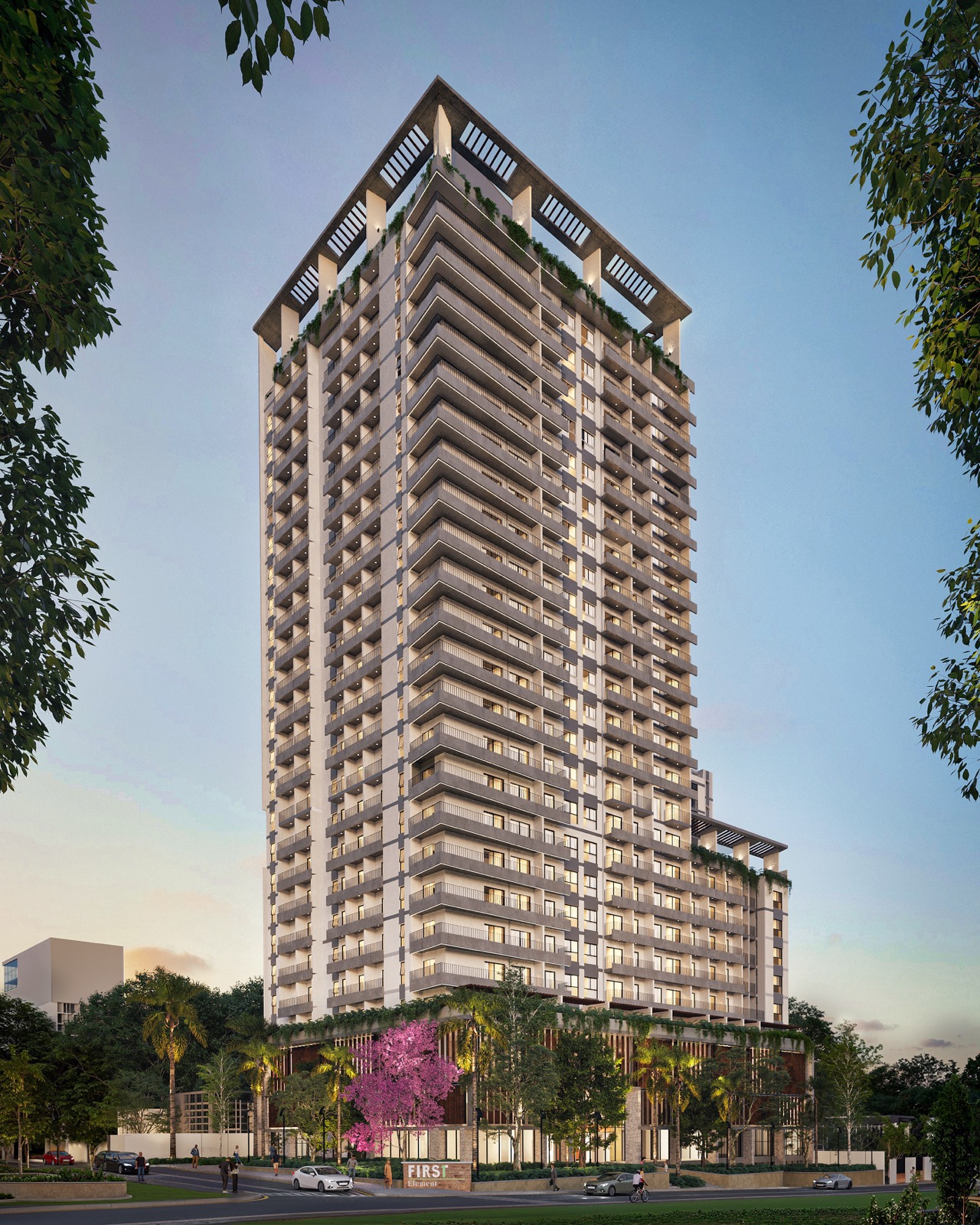 Torre residencial en Asunción al atardecer, con su acceso y las veredas arboladas